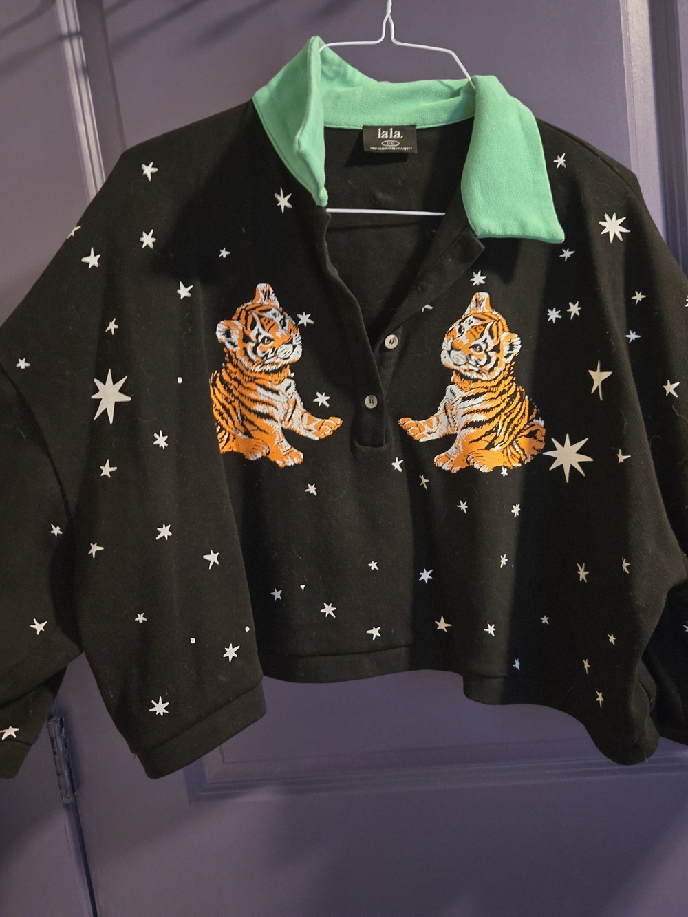 Dressed in LALA Black Crop Polo with Green Collar & Orange Tiger Embroidery